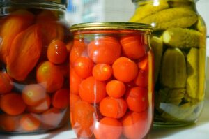 Homemade pickled tomatoes in jars ready to store